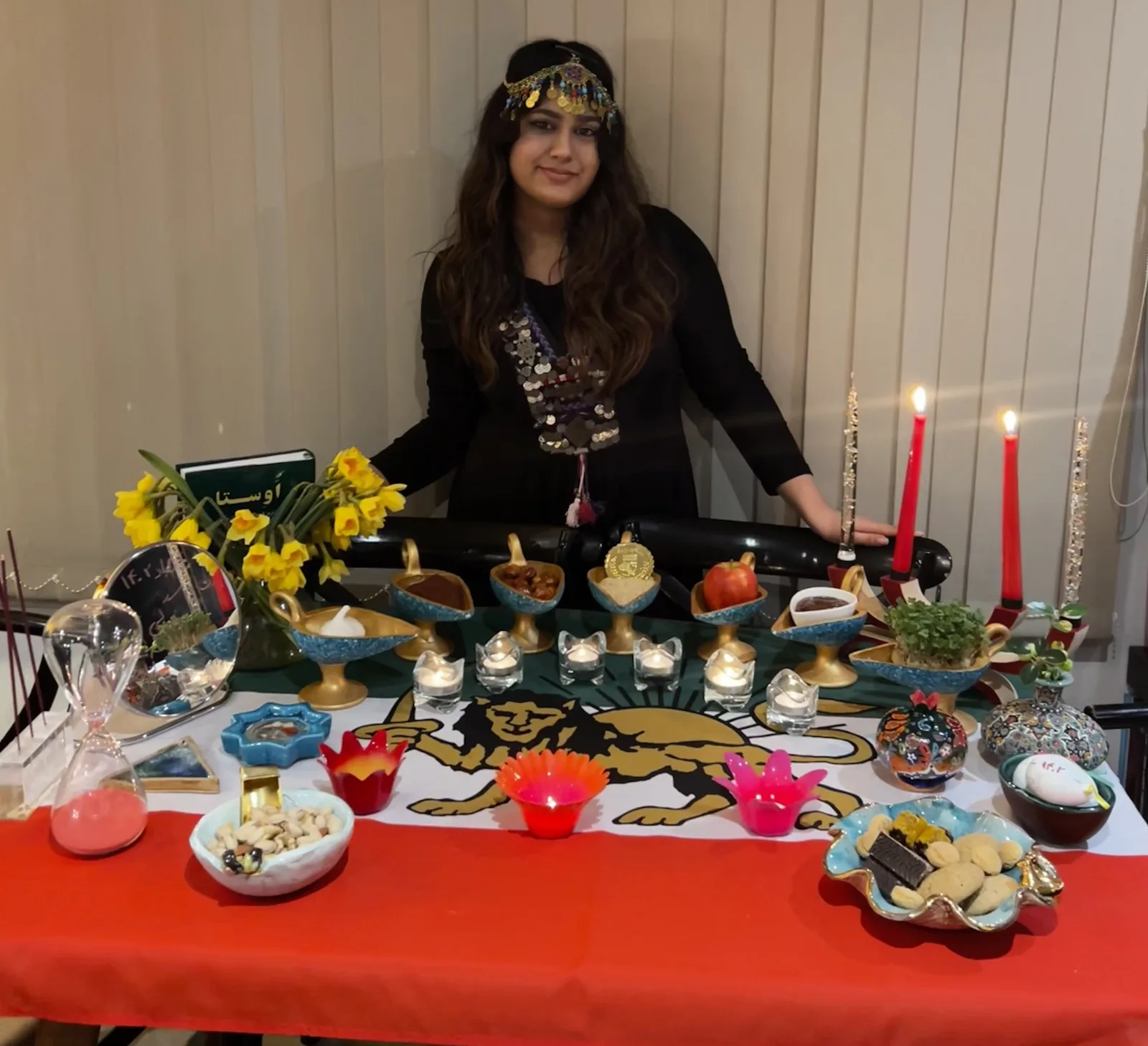 Nika behind a Nowruz haft-sin table